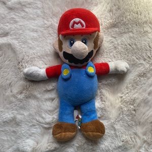 2016 Super Mario Plush with torn button on overalls.